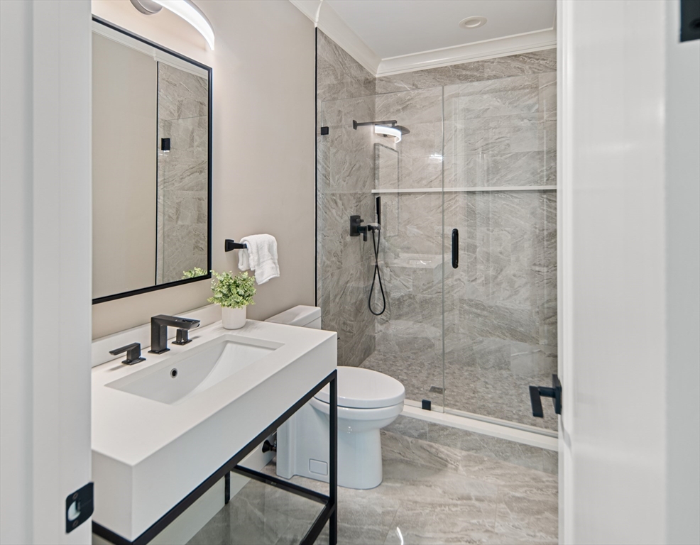 78 Pheasant Landing Road Needham, MA 02492 - Photo 21 of 35 a bathroom with a sink a toilet and shower