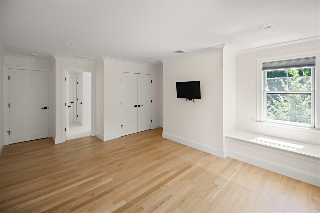 78 Pheasant Landing Road Needham, MA 02492 - Photo 23 of 35 a view of an empty room with wooden floor and a window