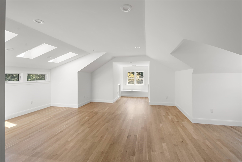 78 Pheasant Landing Road Needham, MA 02492 - Photo 25 of 35 an empty room with wooden floor and windows