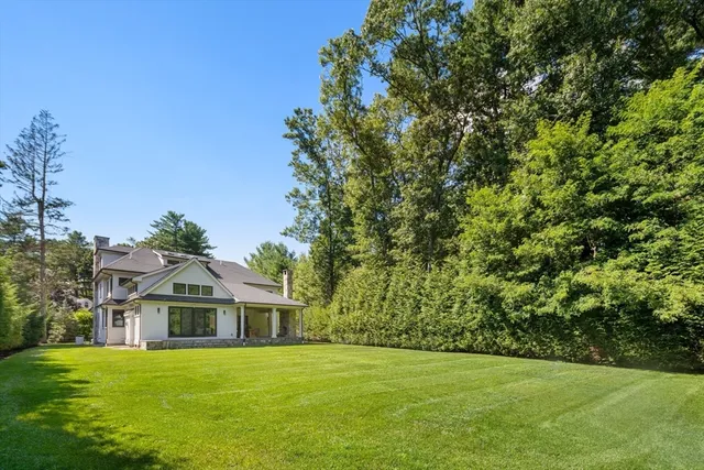 a view of a field with a trees in the background