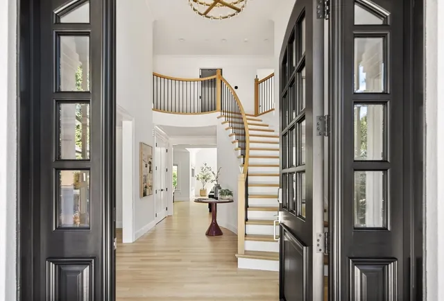 a view of entryway and hall with wooden floor