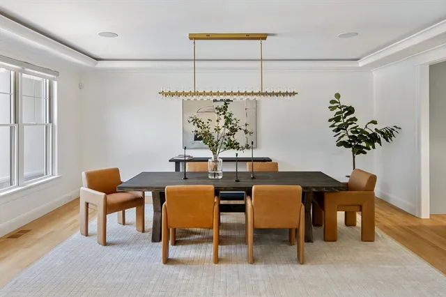a view of a dining room with furniture and chandelier