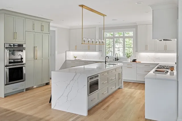 a kitchen with white cabinets and white appliances