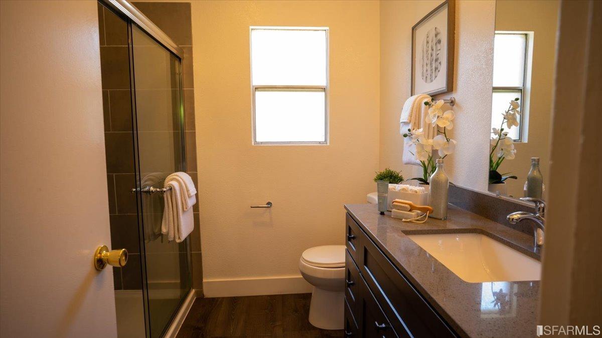 2823 Park Street Berkeley, CA 94702 - Photo 11 of 16 a bathroom with a sink a toilet and a mirror