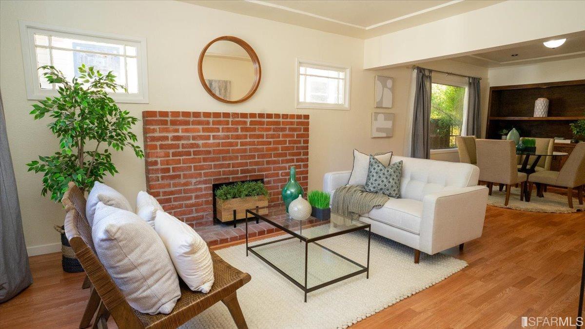2823 Park Street Berkeley, CA 94702 - Photo 4 of 16 a living room with furniture a potted plant and a fireplace