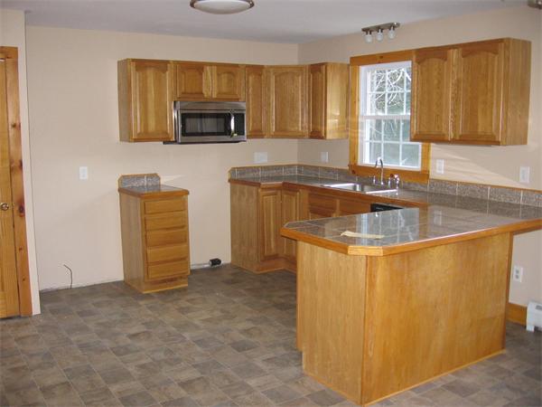 227 Thrower Road Athol, MA 01331 - Photo 5 of 9 a kitchen with granite countertop a sink and a stove top oven