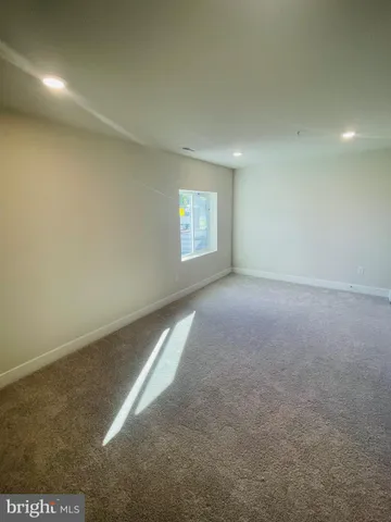 an empty room with windows and ceiling fan view