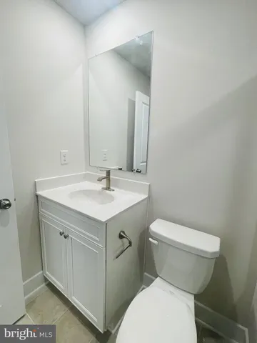 a white toilet sitting next to a bathroom sink