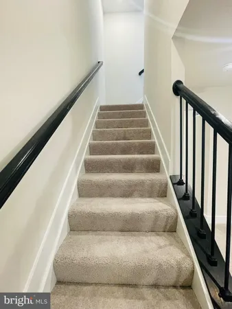 a view of staircase with white walls