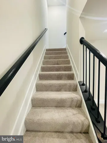 a view of staircase with white walls