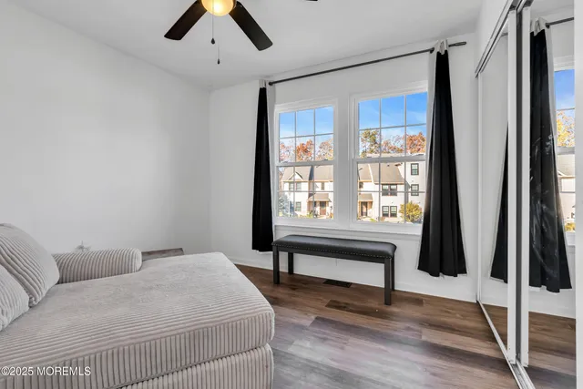 a bedroom with a bed and a large window