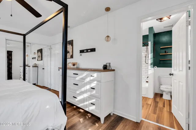 a spacious bedroom with a bed and a view of living room