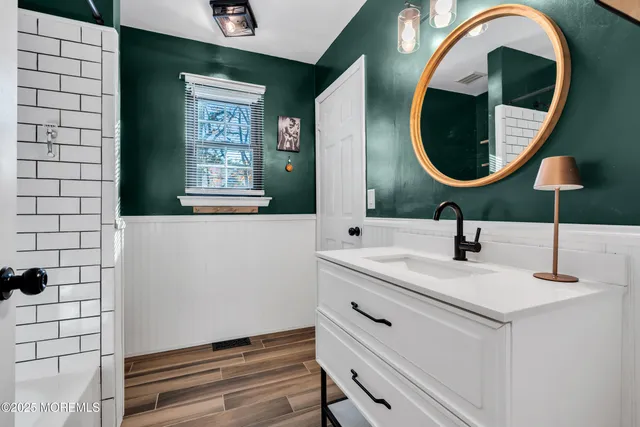 a bathroom with a sink and a mirror