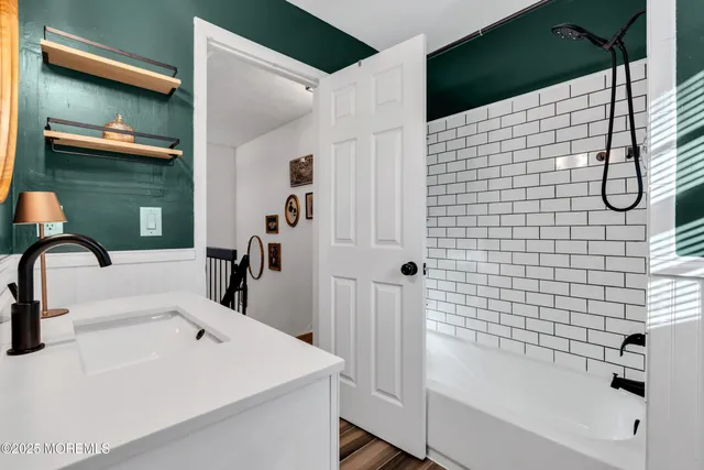 a bathroom with a sink and mirror