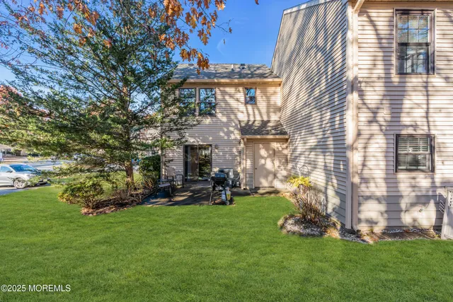 a view of a house with a yard and sitting area