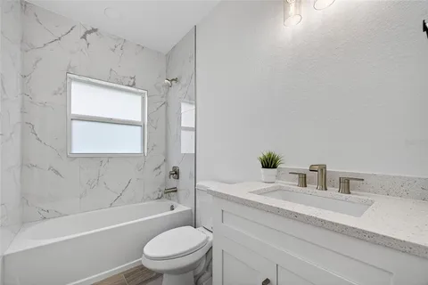 a bathroom with a bathtub and shower