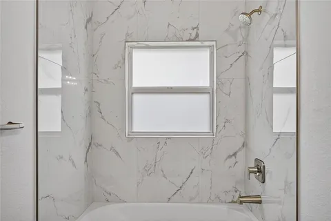a view of washer and dryer with kitchen in the background
