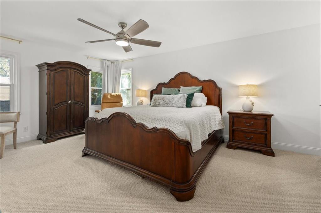 6305 Genoa Road Fort Worth, TX 76116 - Photo 14 of 33 a spacious bedroom with a bed and a ceiling fan