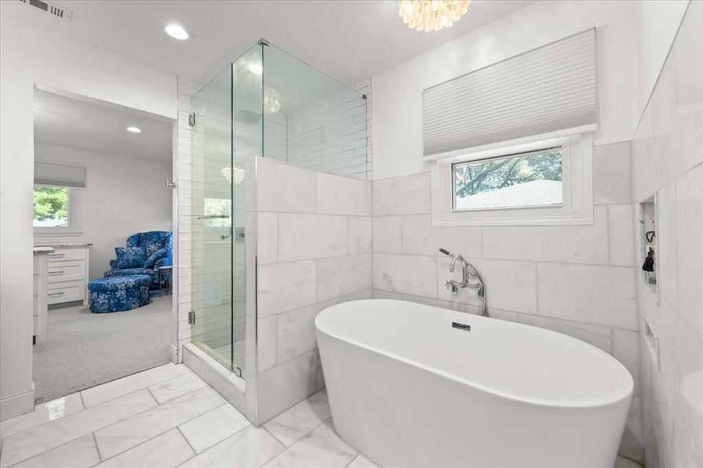 6305 Genoa Road Fort Worth, TX 76116 - Photo 16 of 33 a white bath tub sitting in a en suite bathroom