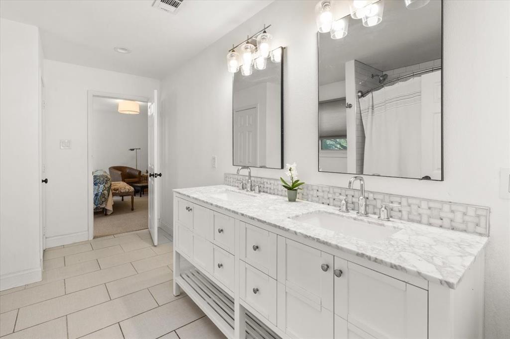 6305 Genoa Road Fort Worth, TX 76116 - Photo 24 of 33 a en suite bathroom with a granite countertop double vanity sink and a mirror