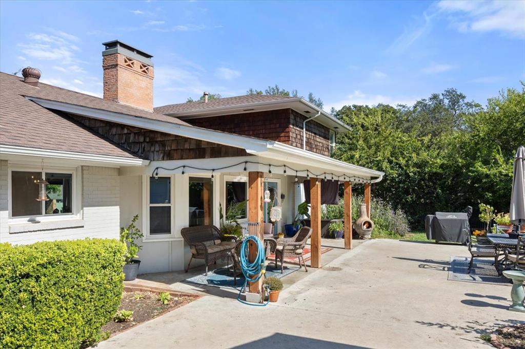 6305 Genoa Road Fort Worth, TX 76116 - Photo 27 of 33 a view of a patio with table and chairs potted plants and a large tree