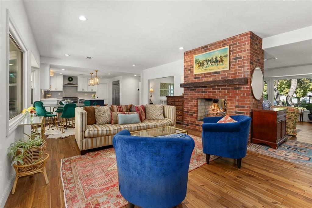6305 Genoa Road Fort Worth, TX 76116 - Photo 4 of 33 a living room with furniture a fireplace and a table