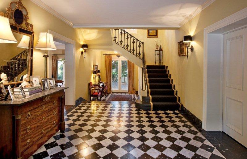 810 Lilac Drive Montecito, CA 93108 - Photo 2 of 14 a view of a hallway with wooden cabinets and black chairs