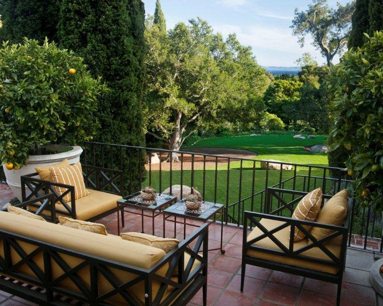 810 Lilac Drive Montecito, CA 93108 - Photo 8 of 14 a roof deck with table and chairs and potted plants with wooden floor and fence
