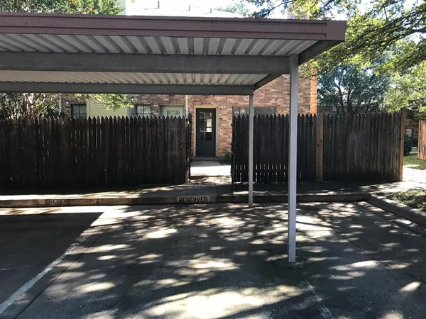 a backyard of a house with a table and chairs