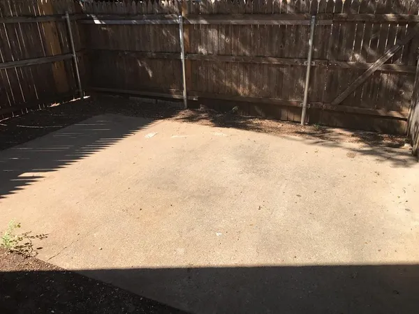 a small yard with wooden fence
