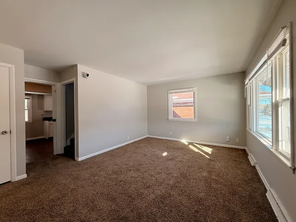 an empty room with windows and closet