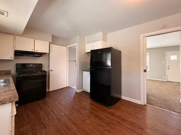 a kitchen with a refrigerator and a stove