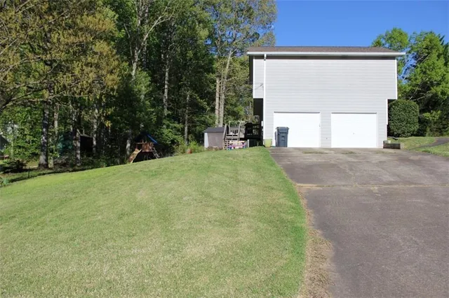 a view of a house with a yard and garage