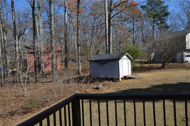 a view of a yard with wooden fence
