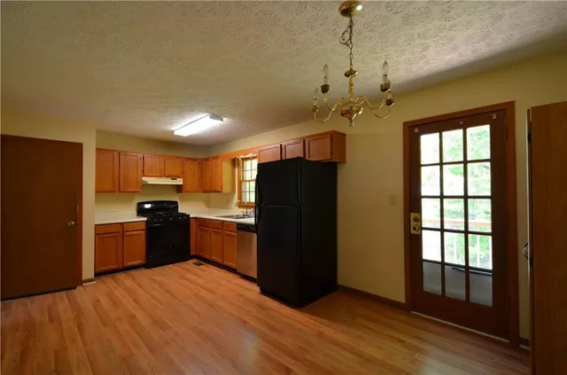 a kitchen with granite countertop stainless steel appliances and wooden cabinets