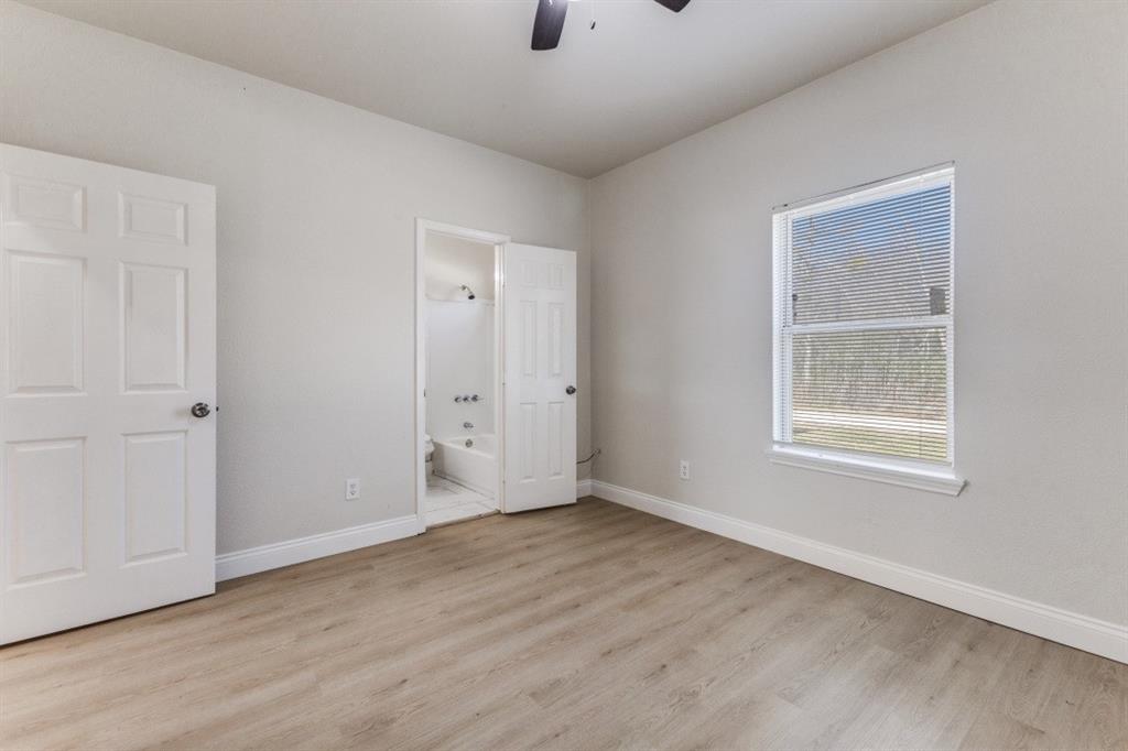 711 South 3rd Avenue East Dawson, TX 76639 - Photo 7 of 12 a view of an empty room with wooden floor and a window