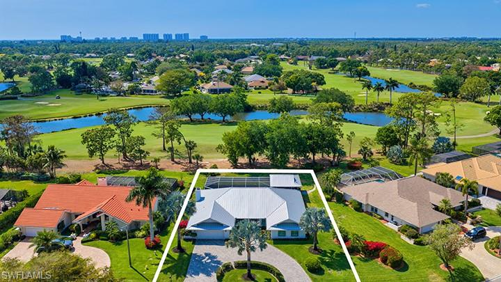 an aerial view of residential houses with outdoor space and lake view
