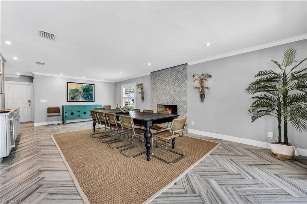 1966 Imperial Golf Course Boulevard Naples, FL 34110 - Photo 11 of 32 a view of a dining room with furniture and a potted plant