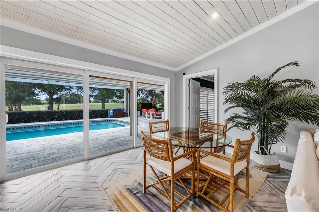 1966 Imperial Golf Course Boulevard Naples, FL 34110 - Photo 12 of 32 a view of a patio with table and chairs and potted plants