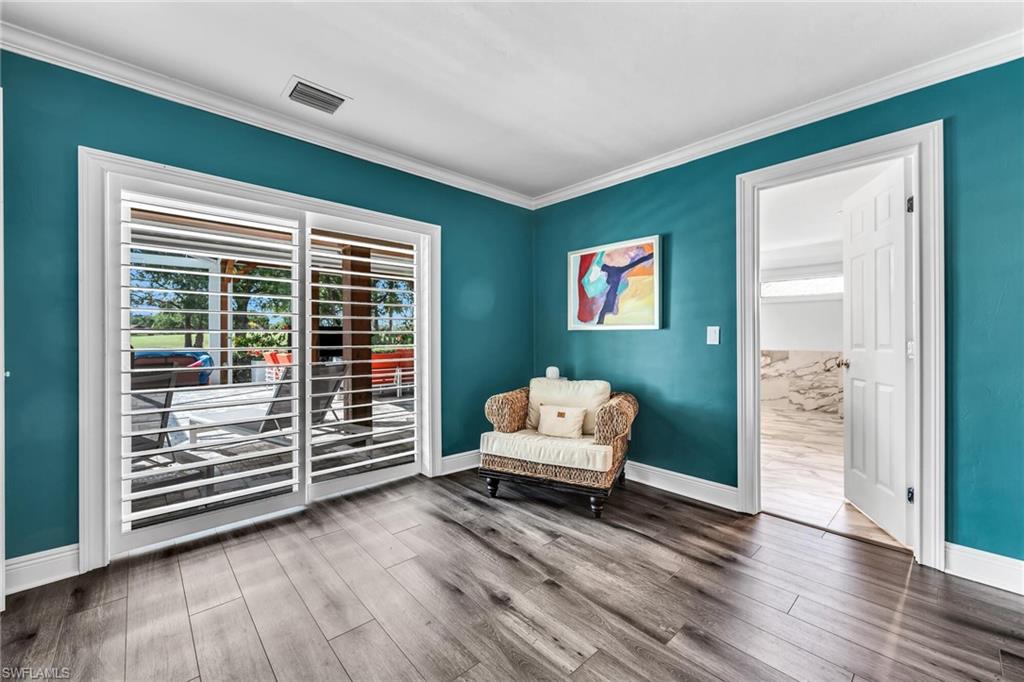 1966 Imperial Golf Course Boulevard Naples, FL 34110 - Photo 16 of 32 a living room with furniture and wooden floor