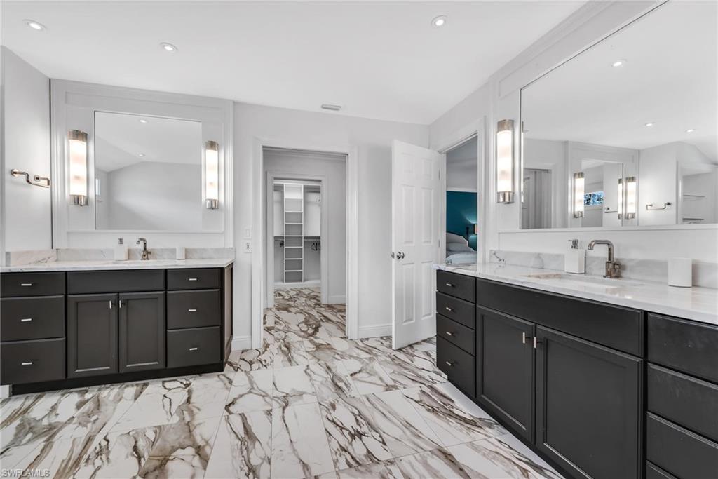 1966 Imperial Golf Course Boulevard Naples, FL 34110 - Photo 17 of 32 a spacious bathroom with a sink double vanity and a mirror