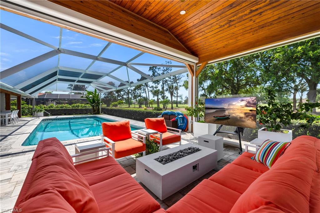 1966 Imperial Golf Course Boulevard Naples, FL 34110 - Photo 2 of 32 a outdoor living space with furniture and a garden