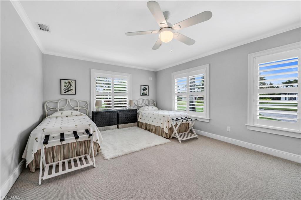 1966 Imperial Golf Course Boulevard Naples, FL 34110 - Photo 21 of 32 a spacious bedroom with two beds and window