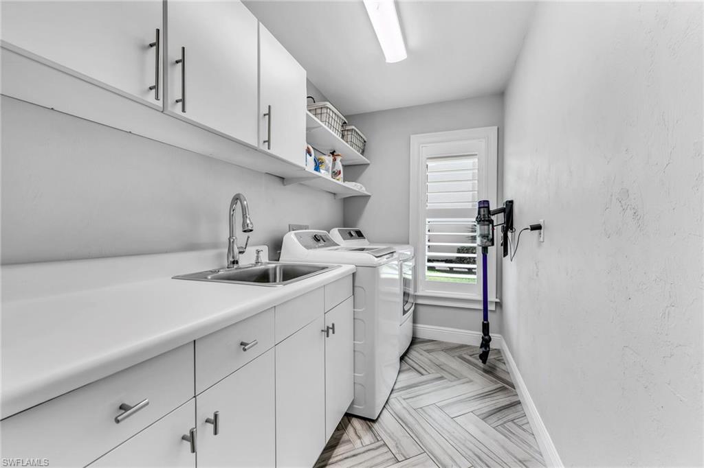 1966 Imperial Golf Course Boulevard Naples, FL 34110 - Photo 24 of 32 a kitchen with sink cabinets and appliances