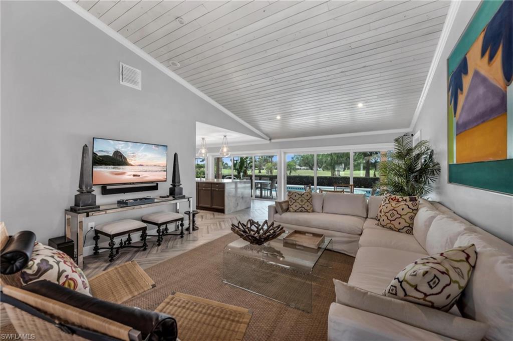1966 Imperial Golf Course Boulevard Naples, FL 34110 - Photo 3 of 32 a living room with furniture floor to ceiling window and potted plant