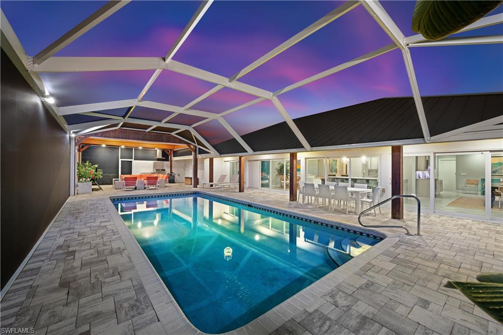 1966 Imperial Golf Course Boulevard Naples, FL 34110 - Photo 31 of 32 a view of a patio with a table and chairs under an umbrella