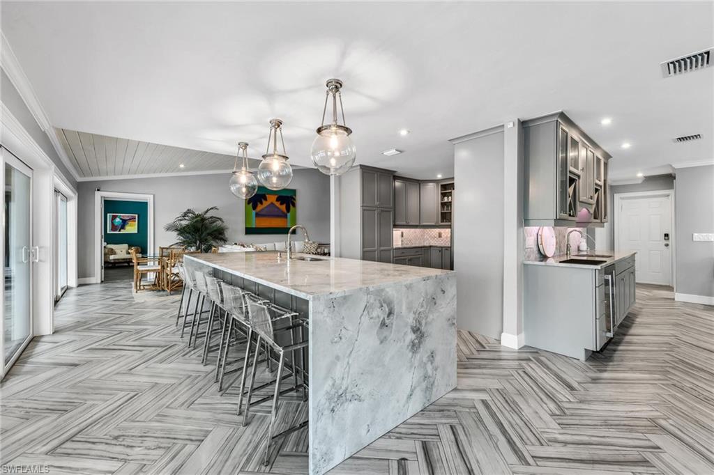1966 Imperial Golf Course Boulevard Naples, FL 34110 - Photo 8 of 32 a view of a kitchen and dining room