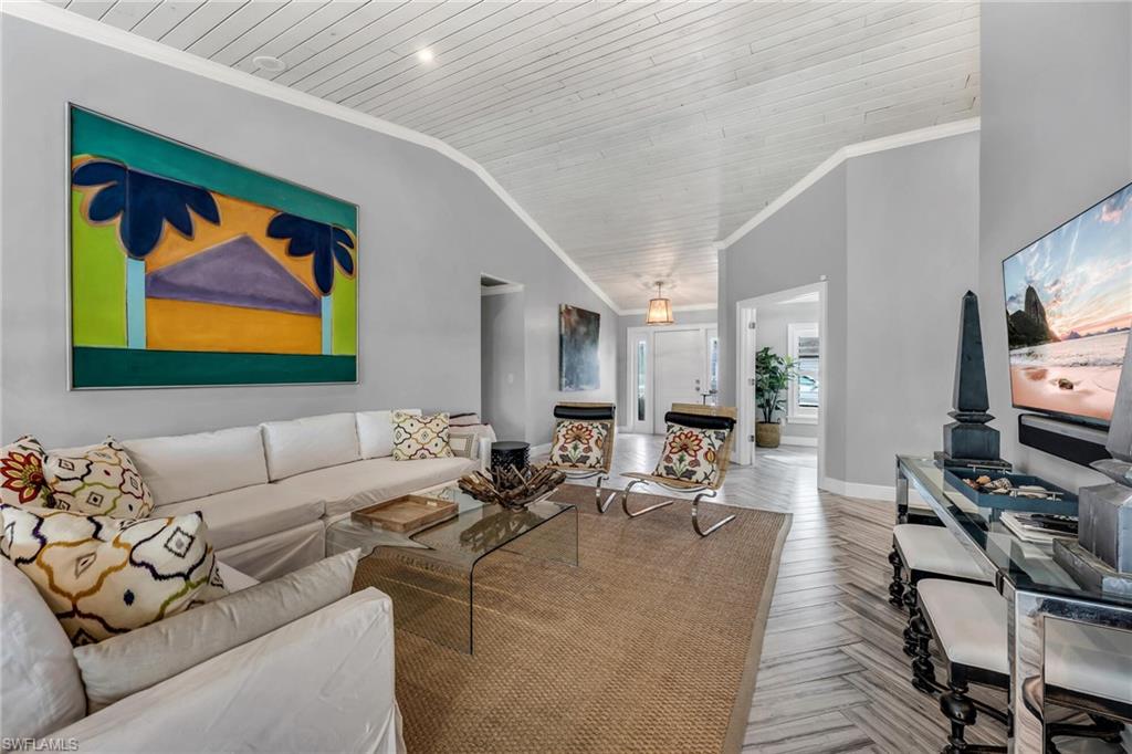 1966 Imperial Golf Course Boulevard Naples, FL 34110 - Photo 9 of 32 a living room with furniture and a flat screen tv