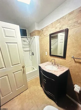 a bathroom with a sink toilet and tub