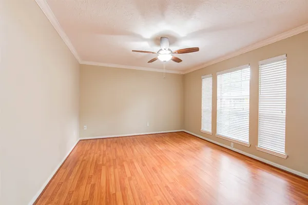 a view of wooden floor and windows in a room